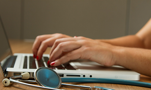 hands typing on a laptop