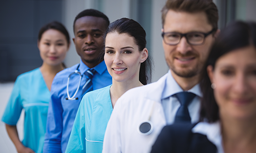 Team of doctors standing in a row.