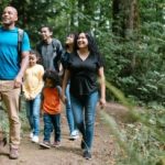 Family walking on trail in woods