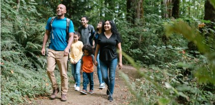 Family walking on trail in woods