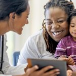 Clinician talking to child and mother