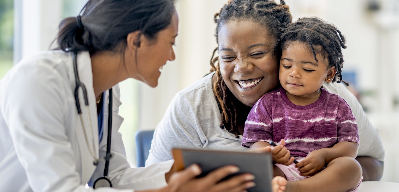 Clinician talking to child and mother