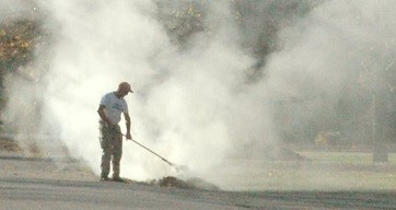 Man burning waste outdoors