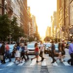 Blurry picture of people crossing street in a city