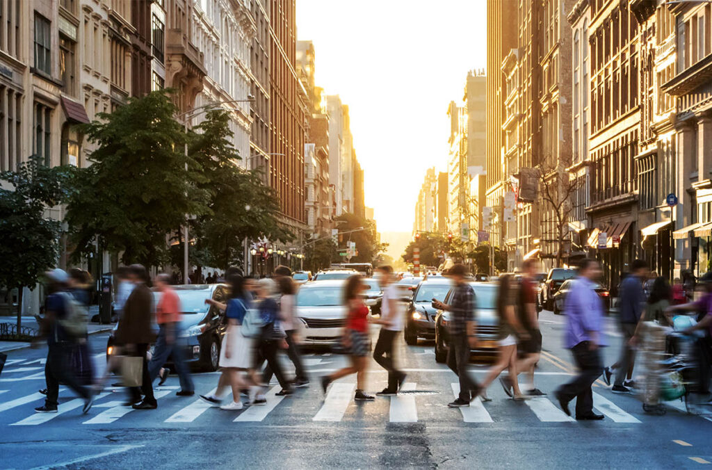 Blurry picture of people crossing street in a city