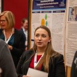 Nurse presenting poster at a conference
