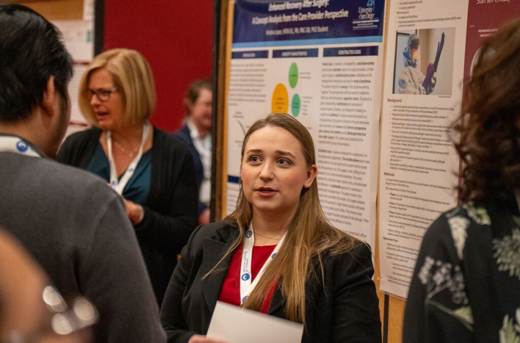 Nurse presenting poster at a conference