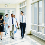 Clinicians walking down a hallway in a hospital