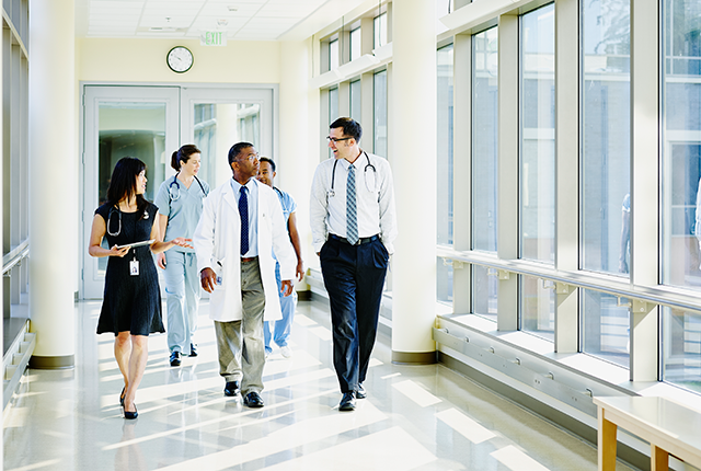 Clinicians walking down a hallway in a hospital