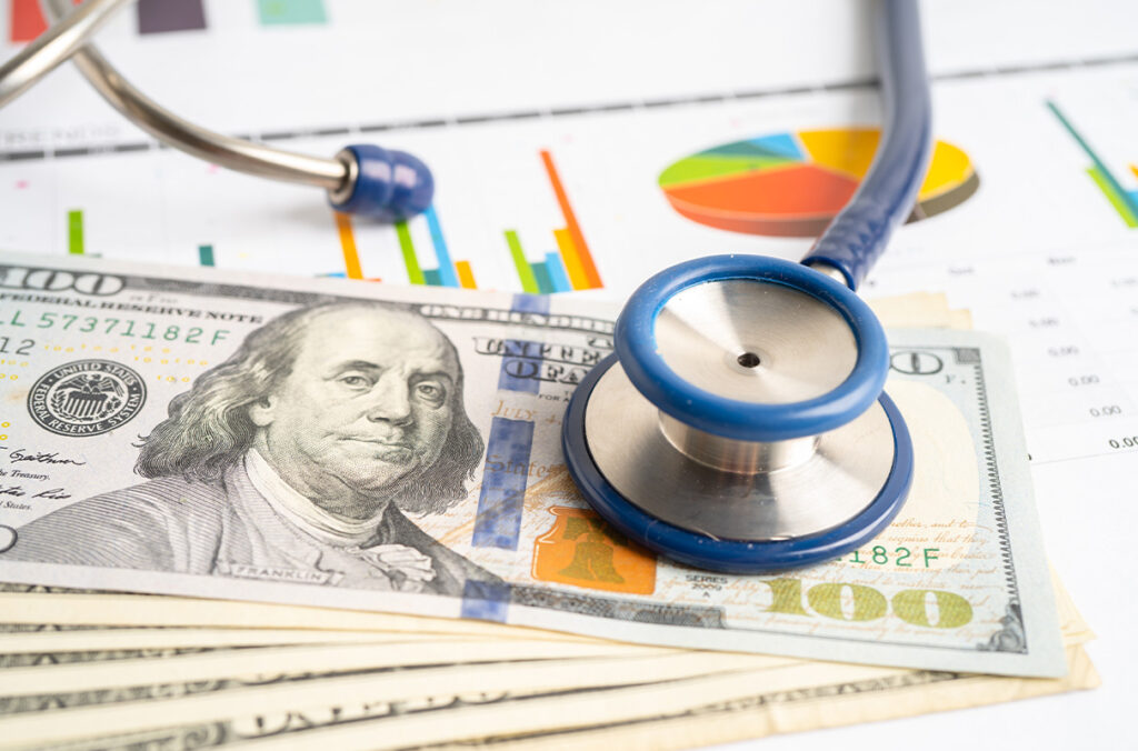 Stethoscope on a pile of paper money.