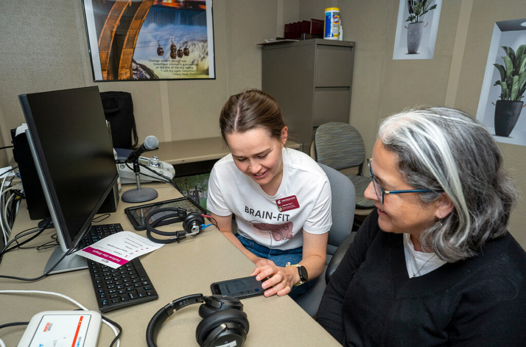 Student testing the hearing of a research study participant